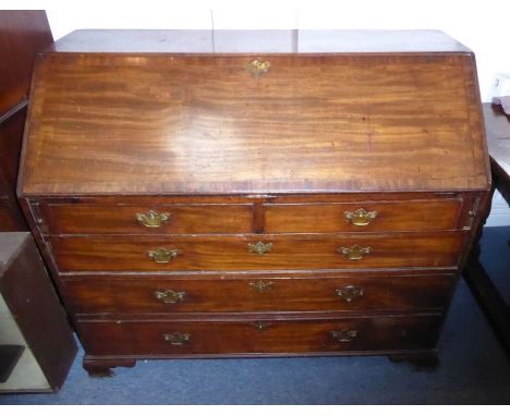 A late 18th century mahogany writing bureau of large proportions; the sloping cross-banded fall opening to reveal fully fitte