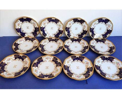 A set of 12 early 20th century fine Coalport porcelain dessert plates: raised, beaded gild rims; triform design with hand-dec