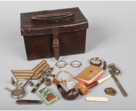 A World War I leather Howitzer sight case containing personal effects. Including, pipes, spectacles, combination campaign cut