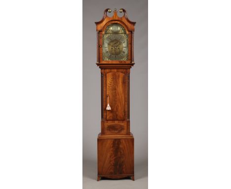 A George III figured mahogany 8 day longcase clock by John Hamilton, Glasgow. With brass arch top dial bearing a silvered nam