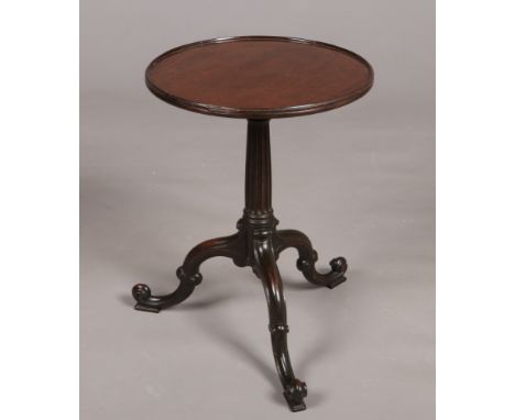 A Chippendale period carved mahogany dish top tripod kettle stand. With reeded centre pedestal and double scrolling supports,