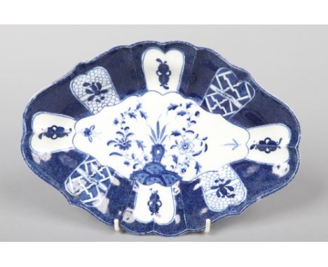 A Caughley scalloped lozenge shaped dessert dish. Powder blue ground and painted in underglaze blue with the Scholar's Rock p