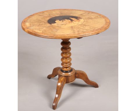 A 19th century Sorrento ware olive wood centre pedestal tripod table. With a marquetry roundel depicting figures and with bur