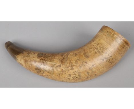 A 19th century scrimshaw cow horn. Incised with a fox hunting scene, topographical views, birds and flowers, 35cm.  