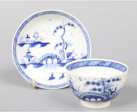 a Caughley teabowl and saucer. Painted in underglaze blue with the Bridge and Windmill pattern c.1780, saucer 12.25cm diamete