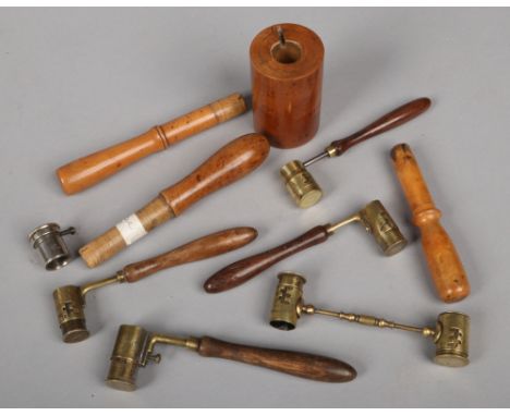 A collection of 19th century French cartridge making tools. Including turned wooden tampers, brass and hardwood powder measur