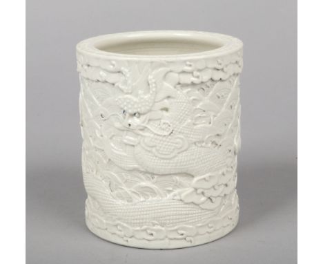 A Chinese Wang Bing Rong blanc de chine brush pot. Decorated in relief with two dragons over a ground of wave scrolls. Impres