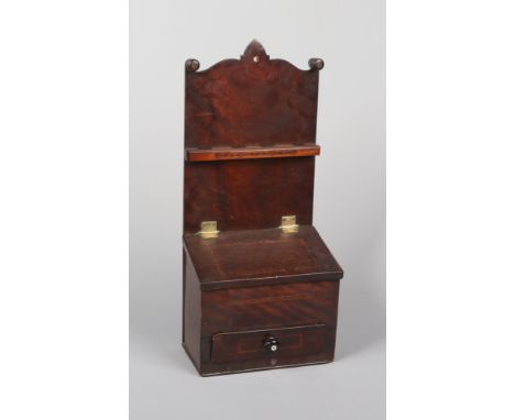 A Georgian oak and mahogany inlaid wall mounting spice box. With undulating cresting rail and incorporating a spoon rack and 
