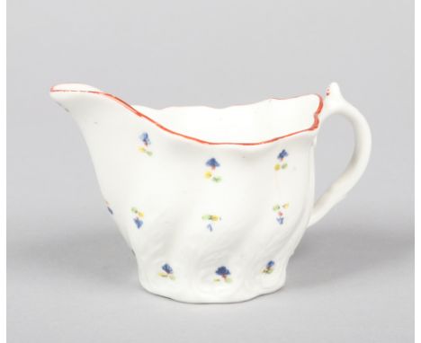 A Caughley low-Chelsea ewer moulded with wrythen leaves. Painted in coloured enamels with cornflowers under a red line rim c.