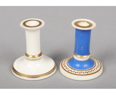 Two Rockingham miniature taper sticks, one blue ground with a trailing gilt border and gilt bands, the other left in the whit