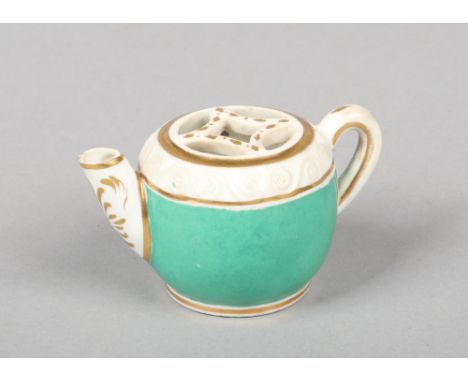 A rare Rockingham voileteer formed as a miniature teapot with pierced grill opening and scroll moulded shoulder. Green ground