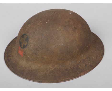 A World War I U.S.A. MKI American Red Cross Brodie helmet. With label and original leather fittings. Along with associated le