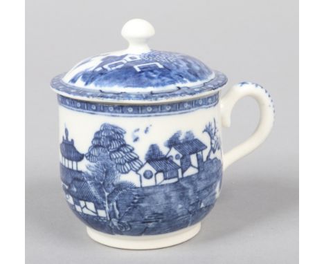 A Caughley custard cup and cover  with scrolling loop handle and button finial. Printed in underglaze blue with the Cottage p