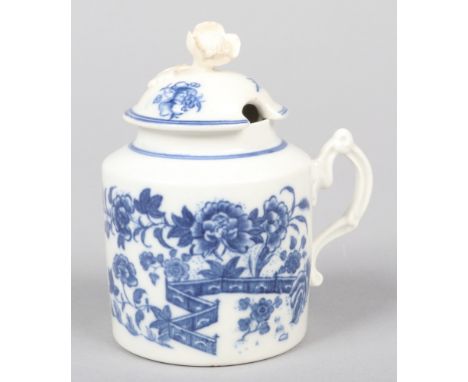 A Caughley mustard pot and cover with flower finial and moulded double scrolling handle. Printed in underglaze blue with the 