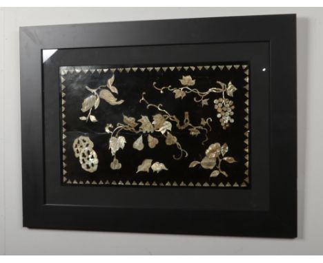 A framed 19th century Chinese lacquer panel with mother of pearl inlay depicting fruiting vines, 29cm x 47cm.  Frame new. The
