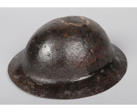 A World War I Model A War Office pattern Brodie helmet with raw edge. Signs of formation markings. Recovered at Mons. Notes; 