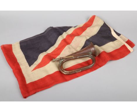 A World War I canvas union flag with rope and wooden toggle along with a copper and brass bugle stamped London Made. Flag 90c