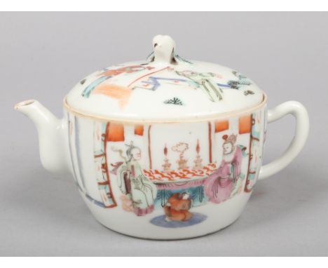 A Chinese Tongzhi (1862-1874) small teapot and cover. Decorated in polychrome enamels with figures dressed in robes and with 