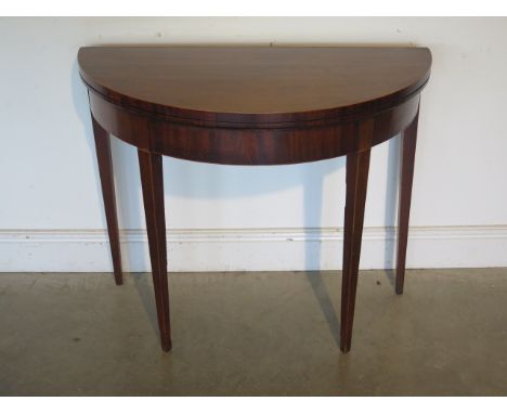 A 19th century mahogany fold over demi lune card table, 92cm wide 