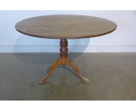 A late Georgian oak tilt top tripod table, 106cm diameter 