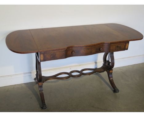 A good quality mahogany and inlaid sofa table with drop flaps and a serpentine central reeded Lyre end supports and brass cas