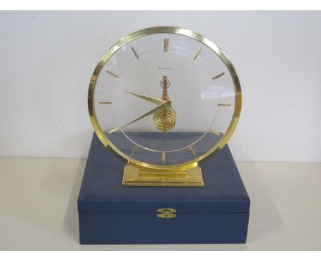 A Jaeger-leCoultre mystery clock with gilt case and baton markers, 19cm tall with original box, running order, case generally