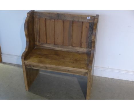 A small rustic pine pew with panel back, length 80cm, back height 90cm, seat height 45cm, depth 42cm 