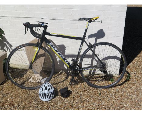A Carrera racing bicycle and helmet - in moderate to good condition