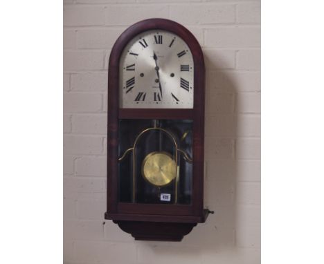 A 1930's wall clock with exposed pendulum - Height 73cm 