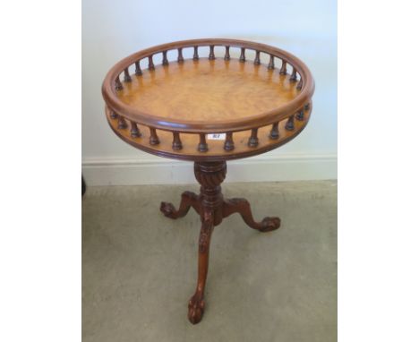 A reproduction walnut tripod wine table with gallery to top over single pedestal terminating in three claw and ball supports 