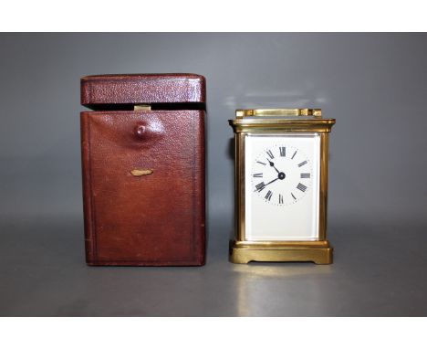 A late 19th early 20th century French carriage clock, stamped to the rear R & Co. made in Paris, full panel dial white enamel