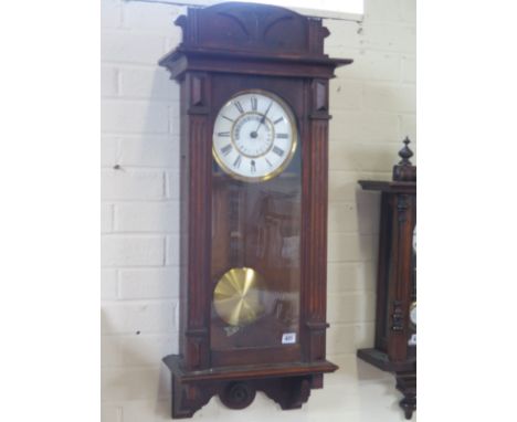 An oak cased Vienna style wall clock with pendulum and key - Height 91cm