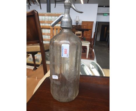 A VINTAGE SODA BOTTLE.