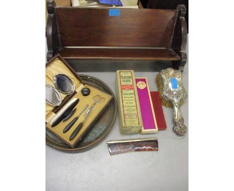 An early 20th century ebonized vanity set in case, a silver backed comb, an Art Nouveau silver plated backed hairbrush, vinta