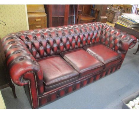 A red Chesterfield button back, three seater sofa 