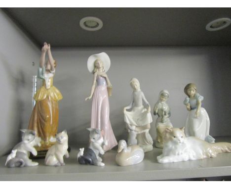 A group of Lladro, Nao and other figurines and animal models to include a Lladro figure of a girl looking towards a rabbit 