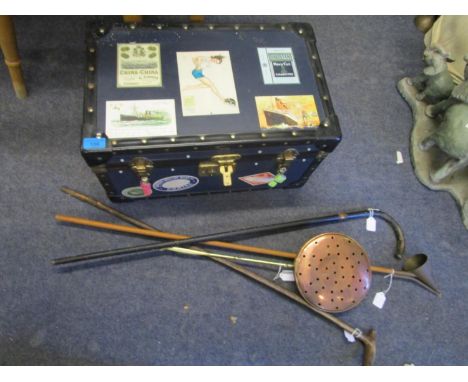 A small travelling trunk with a copper chestnut roaster, two walking sticks and a candle snuffer 