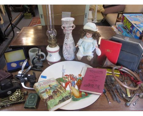 A vintage lot to include a large charger, an oil lamp, a collectors doll, a microscope, a bugle, cutlery to include a silver 