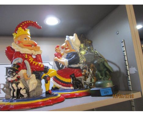 A mixed lot comprising two 20th century cast iron Punch and Judy door stops, a gilt metal wall light and an ornamental monkey