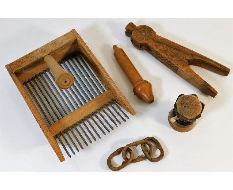 A berry scoop twinned with a carved walnut nut cracker, a Victorian pin cushion, a tree needle case &amp; a folk art carved c