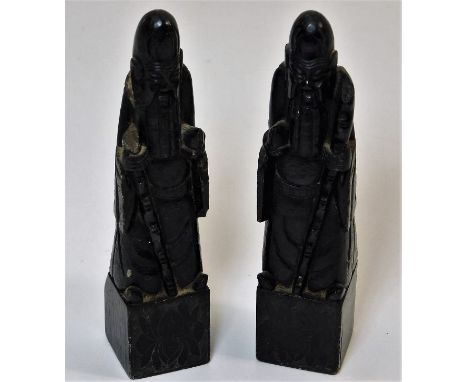 A pair of antique Chinese black jade chess pieces, some faults 5.5in tall