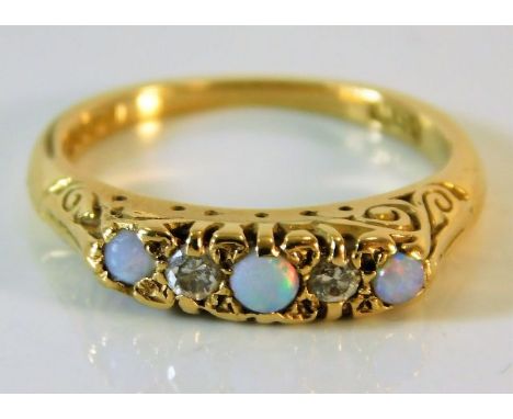 An 18ct gold ring set with opal &amp; diamonds within a carved mount 3.4g size J/K 