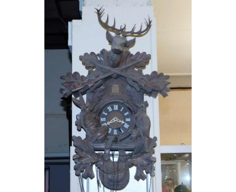A mid 20thC. black forest cuckoo clock with stag &amp; oak leaf decor a/f
