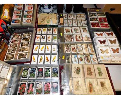 A very large quantity of vintage smokers cards, five albums with covers, one tin of cards including some silks