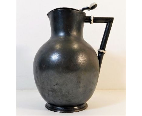 A Christopher Dresser style pewter hot water jug with ceramic fittings 7.25in high