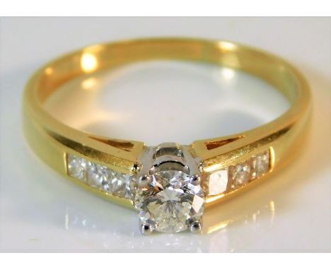 A yellow metal ring set with diamond, centre stone approx. 0.45ct 3.9g size S 