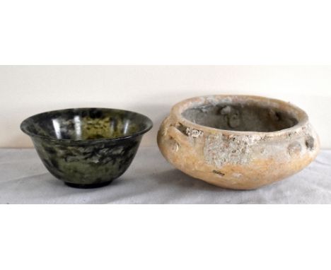 An early Chinese shallow bowl with lug handles and marine encrustation, diameter 13.5cm, and a green tinted bowl, diameter 10