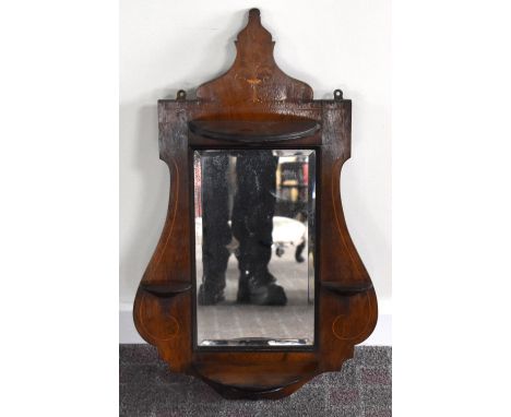 An Edwardian rosewood and inlaid mirrored shelf set with four demilune platforms within a shaped frame, height 71cm.Additiona