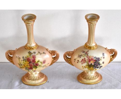 ROYAL WORCESTER; a pair of blush ivory vases with fluted necks and oval bodies decorated with flowers, shape 2051, height 22c