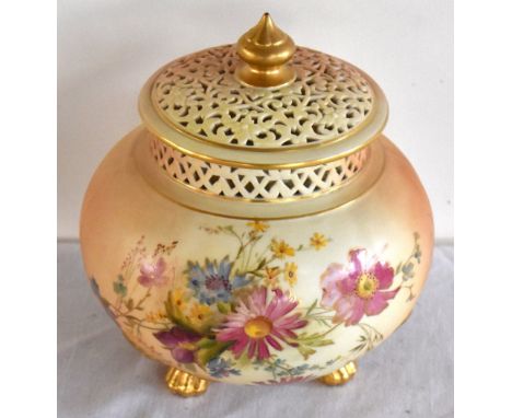 ROYAL WORCESTER; a blush ivory pot pourri vase with inner cover and pierced outer cover, the body decorated with flowers, sha